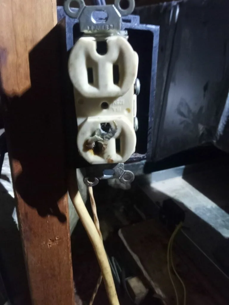 Melted electrical outlet behind a cover plate